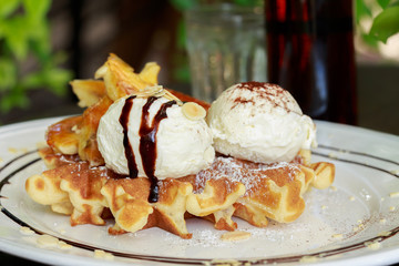 Close up of ice cream and waffle.