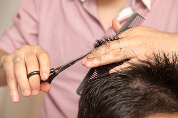 men's haircut with scissors at salon