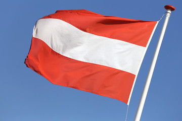 Fototapeta na wymiar Austrian flag blowing in the wind