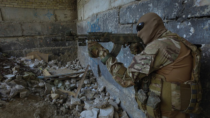 Fototapeta premium The soldier with the weapons and equipment