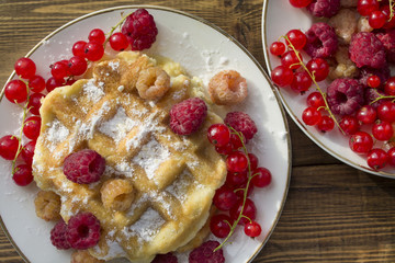 soft waffles with fresh berries, dusted with powdered sugar