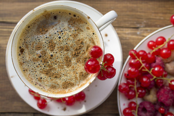 coffee Cup with cinnamon and fresh berries currant and raspberry