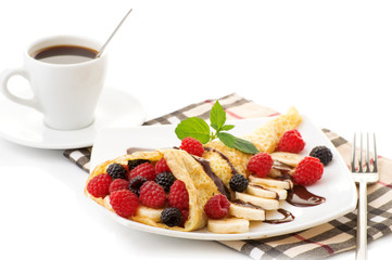 Cup of coffee and pancakes with berries