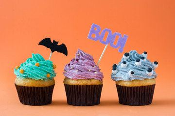 Halloween cupcakes on orange background

