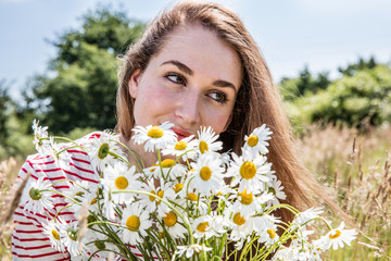 beautiful female teenager with daisy flower bouquet for natural beauty