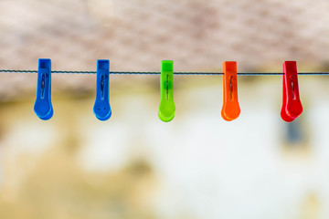 colored clothespins on blurred background