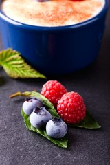 Red and blue berries on slate stone
