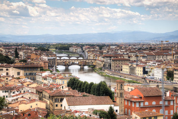 Naklejka na ściany i meble Magnificent view over the historical center of Florence in Italy. The photo is taken from piazzale Michelangelo and shows the Arno river, the Duomo and many other churches and buildings 