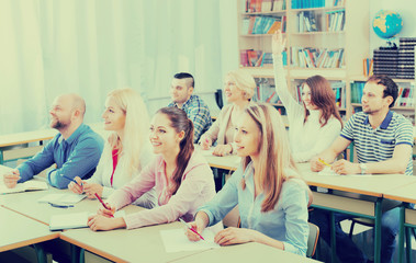 Adult students writing in classroom