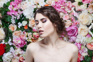 Profile of beautiful fashion girl, sweet, sensual. Beautiful makeup and messy romantic hairstyle. Flowers background.
