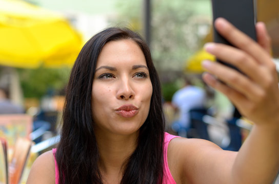 Woman Puckering Lips While Taking Picture