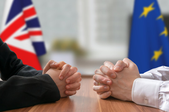 Negotiation of Great Britain and European Union (Brexit). Statesman or politicians with clasped hands.