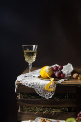 Still life with grapes, walnut. wine, lemon. Naturmort.