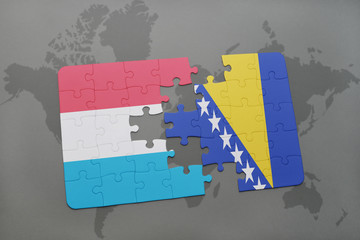 puzzle with the national flag of luxembourg and bosnia and herzegovina on a world map background.