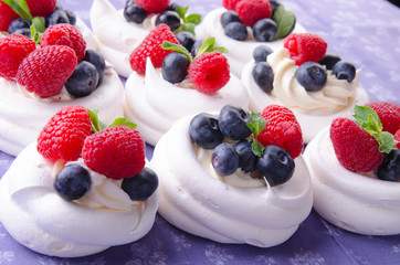 Homemade pavlova meringue cake with fresh berries and whipped cream. Morning. Dessert.