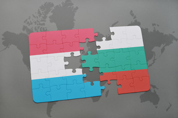 puzzle with the national flag of luxembourg and bulgaria on a world map background.