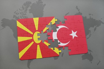 puzzle with the national flag of macedonia and turkey on a world map background.