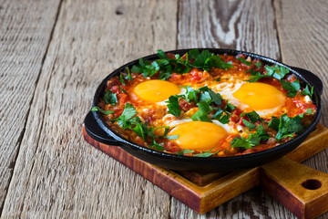 Egg dish with tomato sauce  served in  cast iron pan, shakshouka