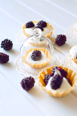 Tartlet with cream an fresh dewberries. Sweet berry summer desse