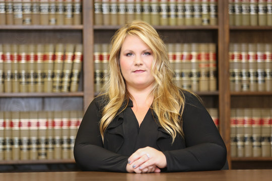 Young attractive female professional, female attorney in law library
