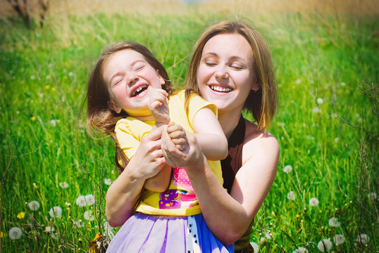 Happy Family takes Fun on Flowers Meadow in Summer - Healthy Lifestyle