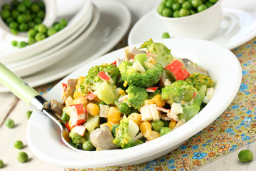 Delicious salad with broccoli, peas and crab stick