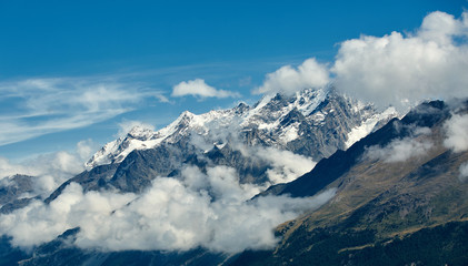 Fototapeta na wymiar Snow capped alpine mountains. Trek near Matterhorn mount.