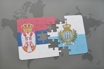 puzzle with the national flag of serbia and san marino on a world map background.