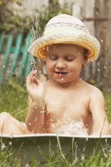 Beautiful baby girl playing with water