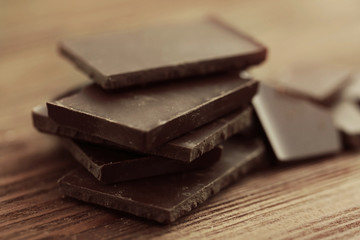 Chocolate pieces on wooden background