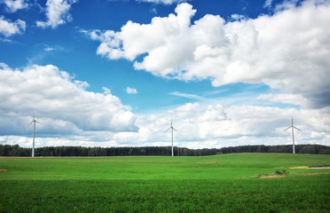 Fototapeta na wymiar Windmills on the green field. 