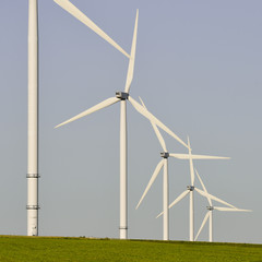 Windmills for electric power production on blue sky