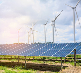 solar panels and wind turbines with the clouds and sky