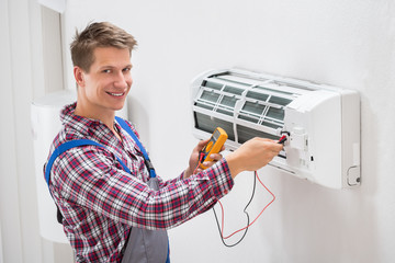 Technician Examining Air Conditioner