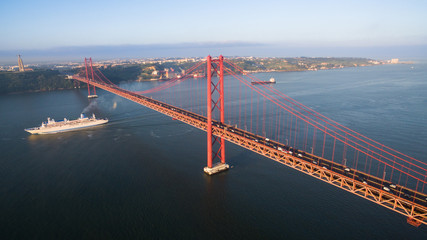 Bridge Ponte 25 de Abril over the Tagus river in Lisbon at morning aerial view - Powered by Adobe