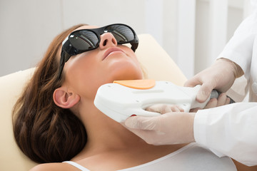 Woman Receiving Laser Hair Removal On Neck