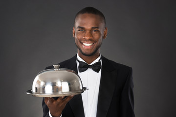 Waiter Serving Meal In Cloche
