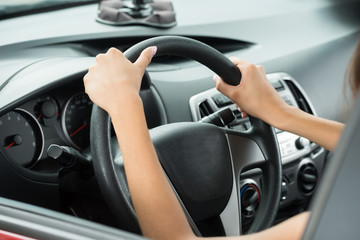Female's Hand Holding Steering Wheel