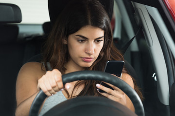 Woman Inside Car Holding Mobile Phone