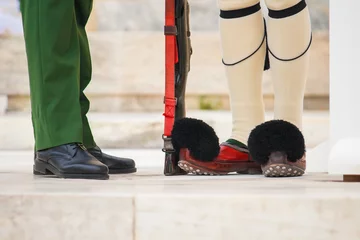 Foto op Canvas Close up image of an evzone's and main officer's feet during the traditional guard change on Syntagma square, Athens, Greece. © tonovavania