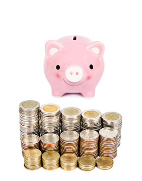 Money coins tower and pink piggybank.