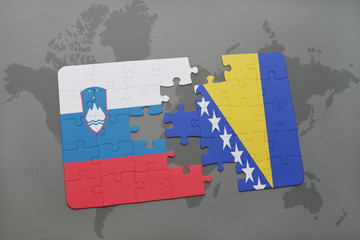 puzzle with the national flag of slovenia and bosnia and herzegovina on a world map background.