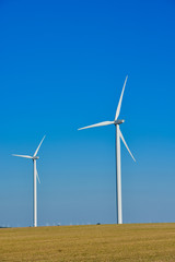 Fototapeta premium Windmills for electric power production on blue sky