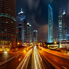 Obraz premium Light trails on the modern building background in Shanghai, China