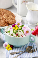 Healthy salad with vegetables and edible flowers.