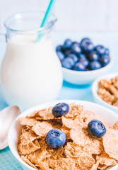 healthy breakfast, cornflakes blueberry and milk, nuts, almond with text space close-up