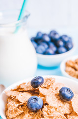 healthy breakfast, cornflakes blueberry and milk, nuts, almond with text space close-up