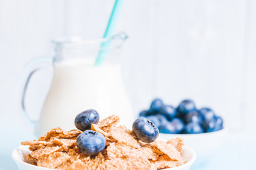 healthy breakfast, cornflakes blueberry and milk, nuts, almond with text space close-up