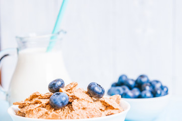 healthy breakfast, cornflakes blueberry and milk, nuts, almond with text space close-up