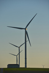Fototapeta premium Windmills for electric power production on blue sky